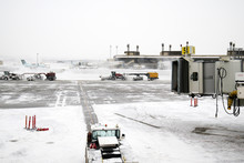 Large Snow Plowing Machines At Work At An Airport.  Cold Snowy Day.