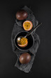 fresh ripe passion fruit on a napkin and slate plate kitchen table can be used as background