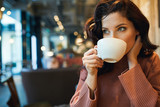 Fototapeta Młodzieżowe - woman drinking coffee in a cafe