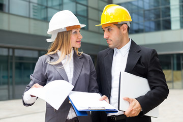 Smiling female designer and her partner are estimating results of their project