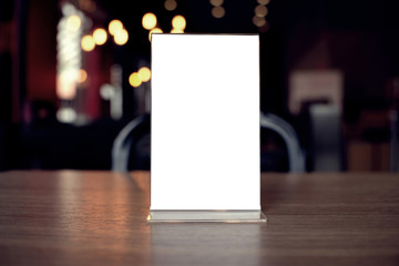 Mock up Menu frame standing on wood table in Bar restaurant cafe. space for text