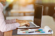 © Somkiat - Freelancing woman using laptop computer for distance job while sitting in coffee shop. Business woman typing on laptop at workplace Woman working in home office hand keyboard.