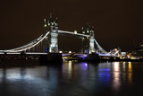 Fototapeta Londyn - The beautiful Tower Bridge, London, UK captured on a cold and frosty evening with light reflections