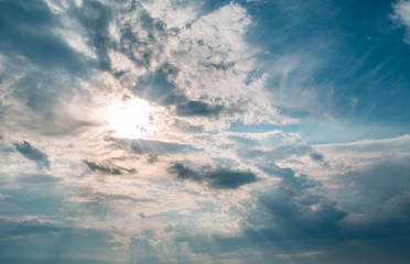 sun rays against a blue sky in the clouds