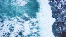 Top View Moving Up Away Ocean Blue Waves Crash Coastline Cliff Drone Footage
