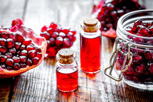 Sliced Pomegranate And Extract In Glass On Wooden Background