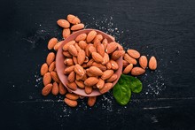 Almond Nuts On A Dark Wooden Background. Healthy Snacks. Top View. Free Space For Text.
