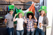 © LIGHTFIELD STUDIOS - multiethnic friends celebrating saint patrick day at home