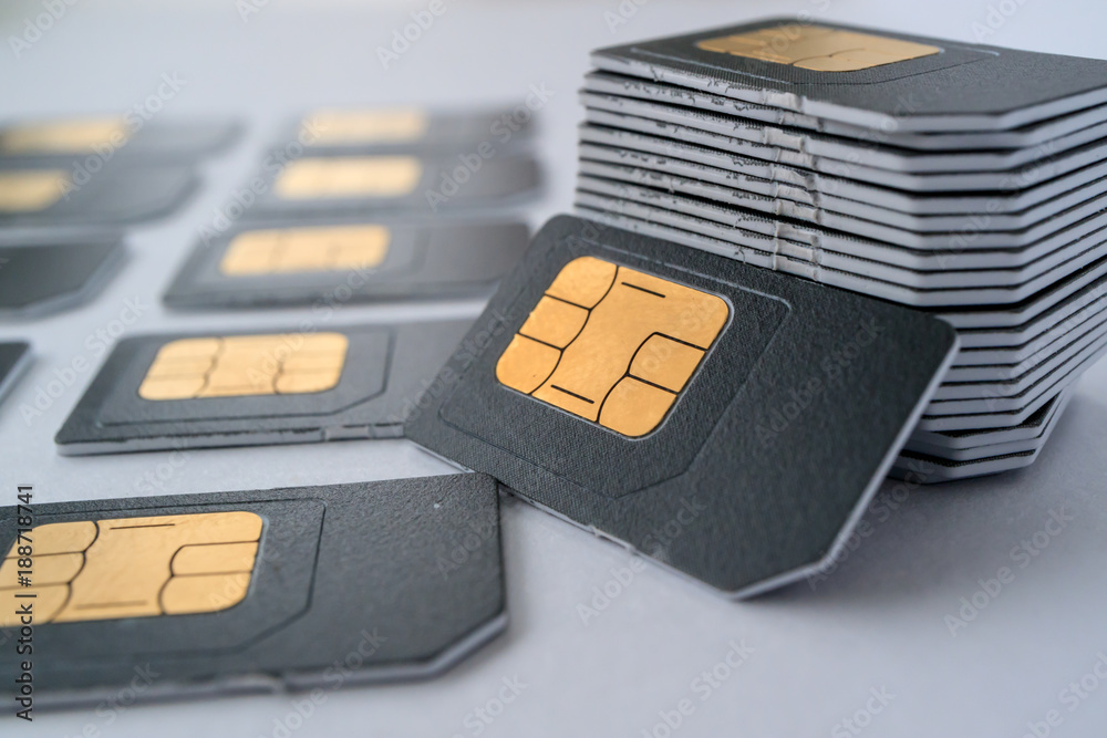 SIM cards for mobile phones in one stack leaning against the stack - obrazy, fototapety, plakaty 