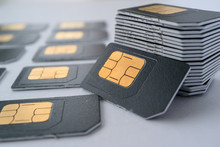 SIM Cards For Mobile Phones In One Stack Leaning Against The Stack