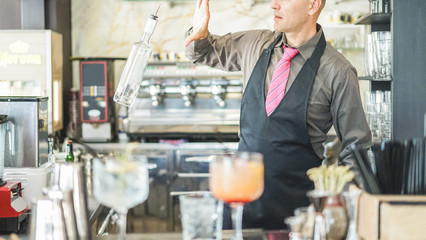 Wall Mural - Bartender doing flair inside american bar