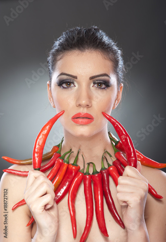 Portrait Of Beautiful Young Woman With Red Hot Chili Peppers