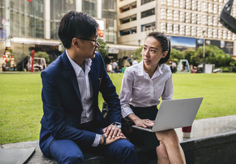 Asian business people working together in a city