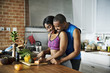 Black couple cooking healthy food in the kitchen