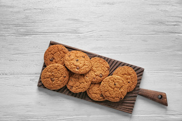 Poster - Delicious oatmeal cookies with chocolate chips on wooden board