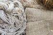 Natural color threat on blurred hessian fabric, natural material concept