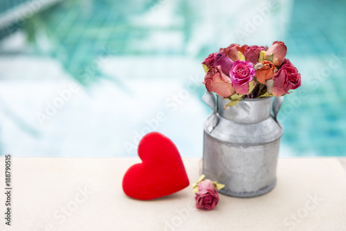 Paper Rose Flower In Metal Can And Red Heart Over Blurred Blue Water Paper Rose Flower In Metal Can And Red Heart Over Blurred Blue Water Outdoor Day