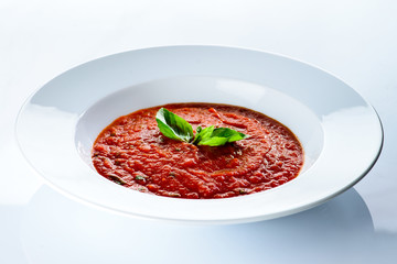 Wall Mural - Ukrainian traditional borsch. Beetroot red soup with meat, garlic and mint in a plate on white background