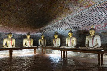 Wall Mural - Group of sitting Buddha statues in cave buddhist temple