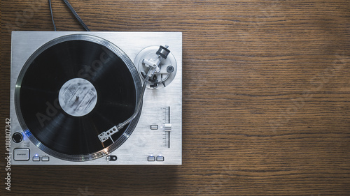 over the head view of the turntable playing the record on the table isolated Poster Mural XXL