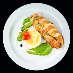 Canvas Print - Grilled chicken fillet with pesto, spinach and sauce in a white plate. Top view, flat lay