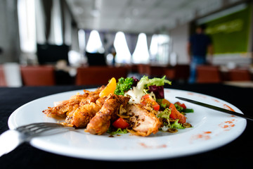 Poster - Delicious juicy roasted meat with spices and tomato in a white plate in a cafe, shallow dof