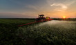 © Dusan Kostic - Tractor spraying pesticides on vegetable field with sprayer at spring