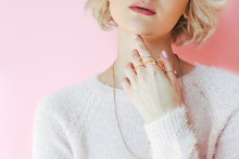 Cropped Shot Of Sensual Young Woman Holding Jewelry In Hand Isolated On Pink