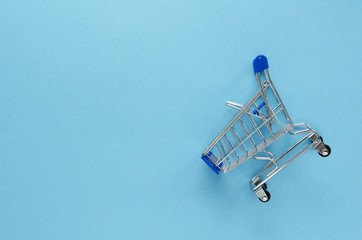 empty shopping cart on blue background