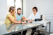 © rh2010 - Young couple having a consultation with a senior doctor in the white office