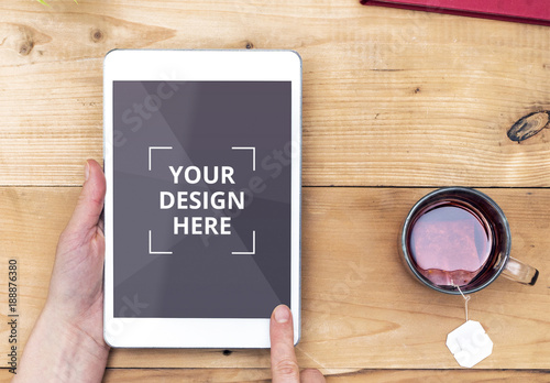 Download Ebook Mockup Of Tablet User With Tea On Wooden Table Stock Template Adobe Stock