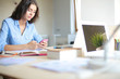 © lenets_tan - Beautiful young business woman sitting at office desk and talking on cell phone. Business woman