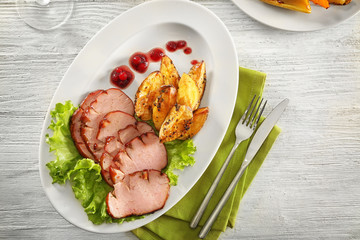 Poster - Plate with sliced honey baked ham and potato on wooden table