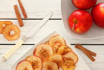 Wall Mural - Composition with apple chips and cinnamon sticks on wooden background