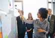 © Flamingo Images - Diverse team of colleagues brainstorming together in a modern office