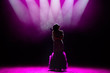 © nagaets - Silhouette of singer on stage. Dark background, smoke, spotlights