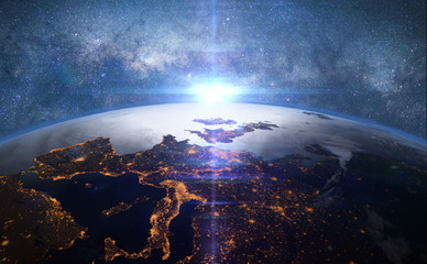 Wall Mural - sunset over the planet Earth in front of the Milky Way galaxy