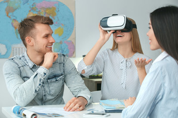 young couple in a tour agency communication with a travel agent travelling concept virtual reality h