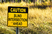 Closeup of a Caution Blind Intersection Ahead sign