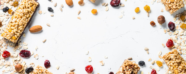 Wall Mural - Granola bar with nuts, fruit and berries on white.
