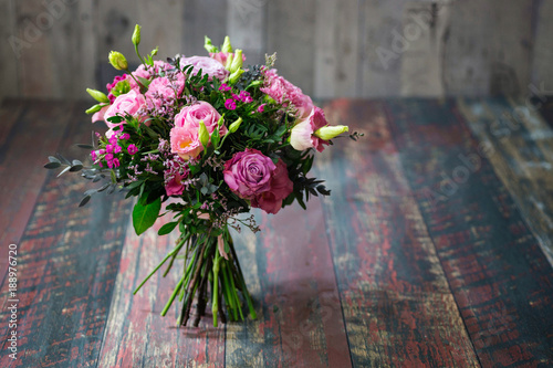 Obraz na PCV Rustic wedding bouquet with roses and Lisianthus flowers in different shades of pink.