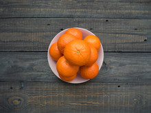 Ripe Mandarins Of Large Size In A Plate On A Wooden Table