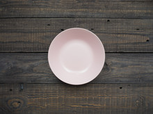 Pink Plate On An Old Wooden Table