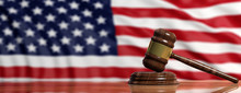 Judge Or Auction Gavel On US America Flag Background. 3d Illustration