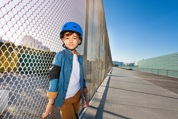 Wall Mural - Happy boy in helmet standing at outdoor rollerdrom