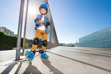 Wall Mural - Young inline skater standing at outdoor rollerdrom