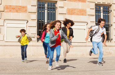 Wall Mural - Cute pupils running  from school building