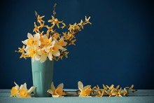 Daffodils In Vase On Blue Background