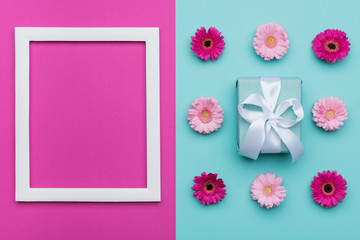 Wall Mural - Happy Mother's Day, Women's Day, Valentine's Day or Birthday Pastel Blue and Pink Candy Colour Background. Floral flat lay minimal concept with beautifully wrapped present.