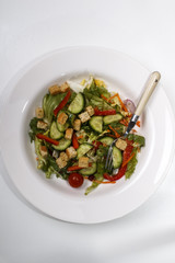 Wall Mural - cucumber salad with croutons and red bell pepper stripes on a plate